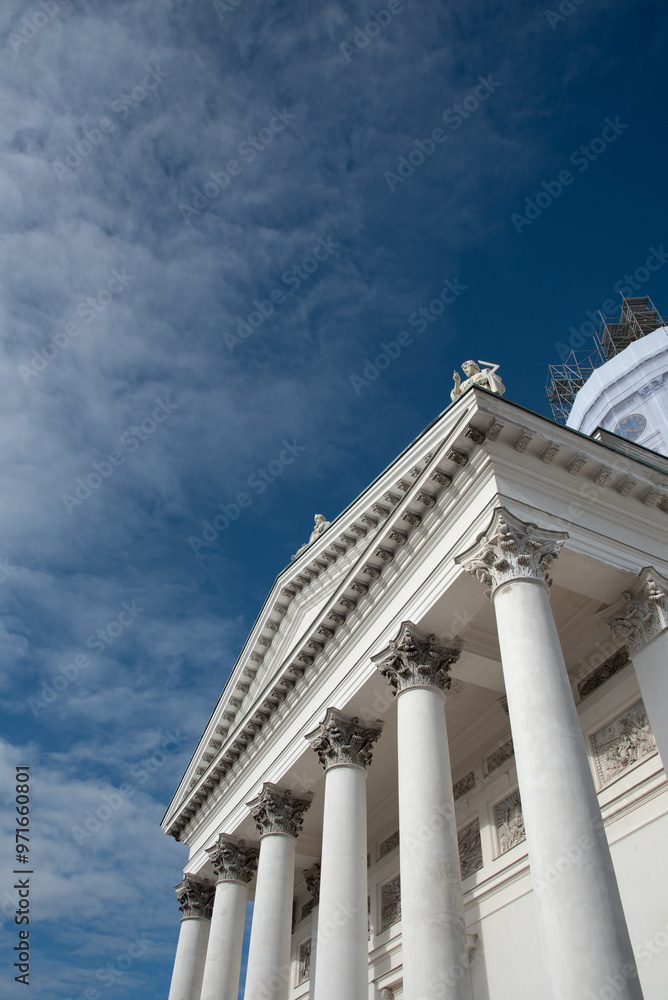 Obraz premium Low angle view of details of the neoclassical style architecture of the cathedral of Helsinki against cloudy sky