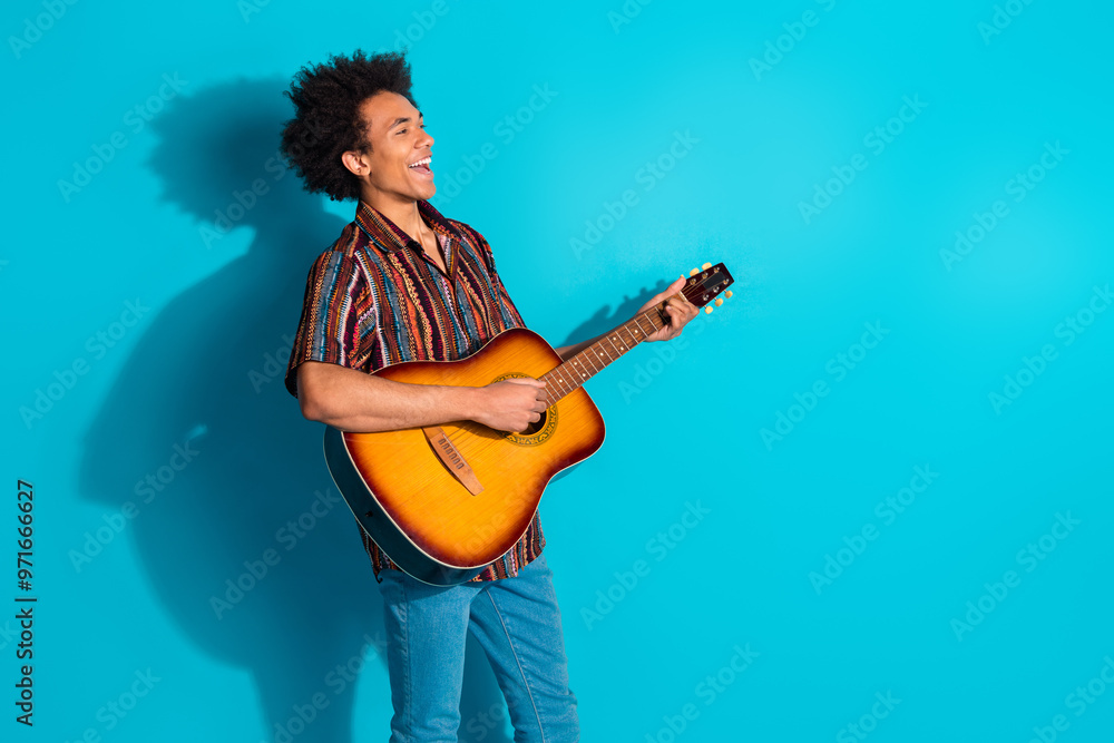 Φωτογραφία Photo of nice young man play guitar sing wear shirt isolated on teal color backg