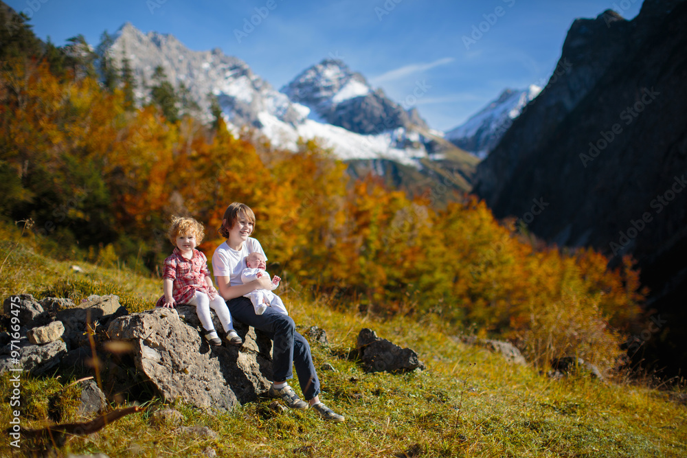 Naklejka premium Family with kids hiking in the mountains
