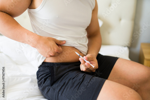 Closeup of a man injecting insulin in his bedroom, focusing on health and wellness. Managing diabetes with self-care and commitment photo