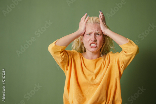 Stressed Young Caucasian Woman on Green Background