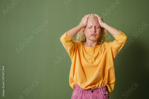 Stressed Young Woman Against Green Background