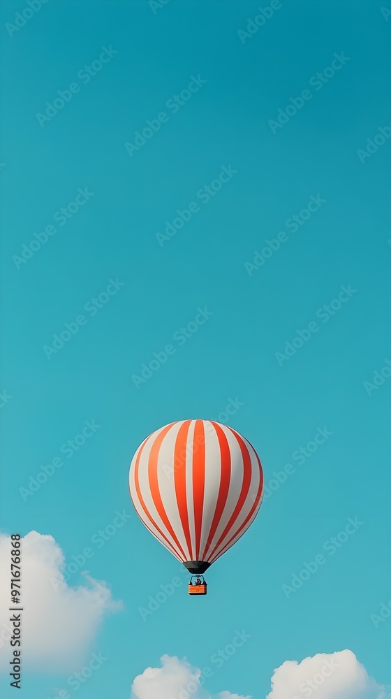 Obraz premium Vibrant Hot Air Balloon Ascending into the Vast Azure Sky