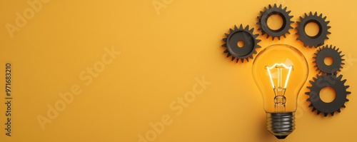 An illuminated light bulb surrounded by black gears against a bright yellow background, symbolizing creativity and innovation. photo