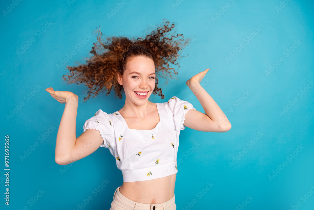 Photo portrait of lovely young lady fluttering hair shampoo dressed stylish white garment isolated on blue color background Photo portrait of lovely young lady fluttering hair shampoo dressed stylish white garment isolated on blue color background