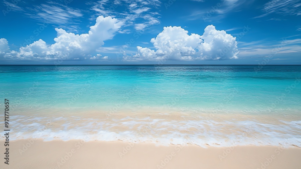 A tranquil beach with crystal clear turquoise water lapping at the white sand shore under a blue sky with fluffy clouds. A tranquil beach with crystal clear turquoise water lapping at the white sand shore under a blue sky with fluffy clouds.