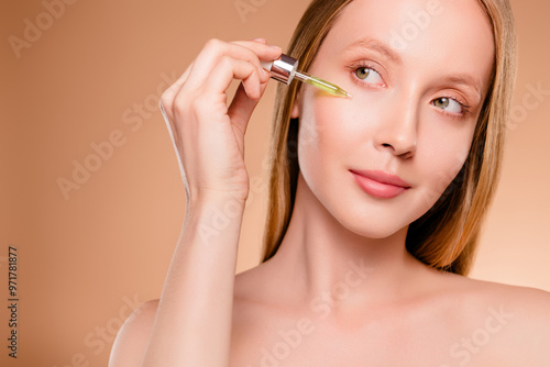 Photo of seductive shiny woman naked shoulders pampering face look emtpy space isolated brown color background