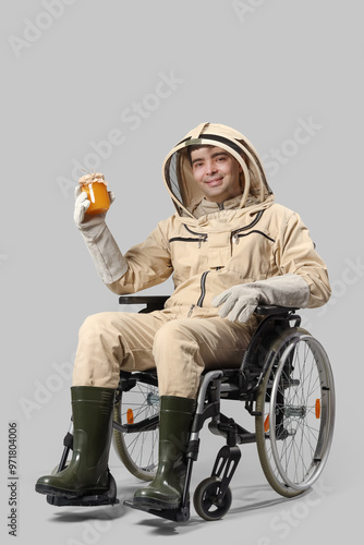 Male beekeeper in wheelchai...
