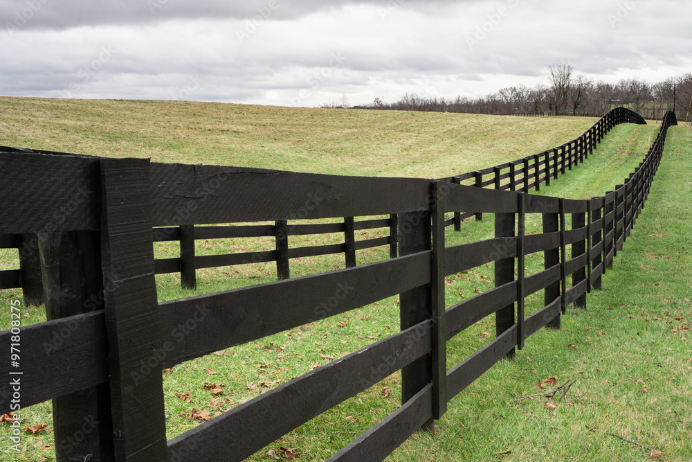 Rolling grassy hills and wood fence post from Kentucky rural landscape Rolling grassy hills and wood fence post from Kentucky rural landscape
