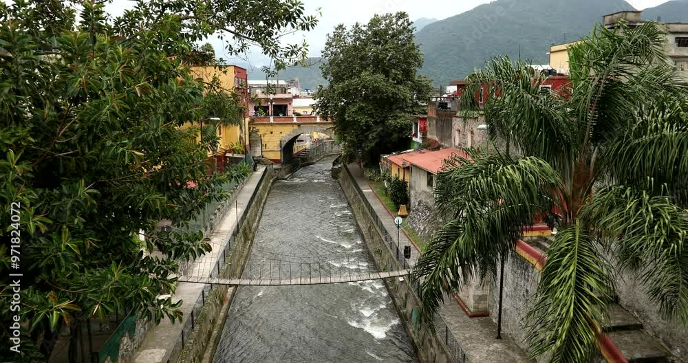 Orizaba, Veracruz, Mexico - July 14, 2022: The channelized river Rio Orizaba flows through the heart of downtown Orizaba. Orizaba, Veracruz, Mexico - July 14, 2022: The channelized river Rio Orizaba flows through the heart of downtown Orizaba.