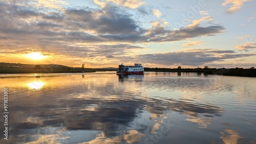 Obraz na płótnie Corrib princes touristic boat cruise on Corrib river at sunset with sky reflection in water, nature background, Galway, Ireland w salonie