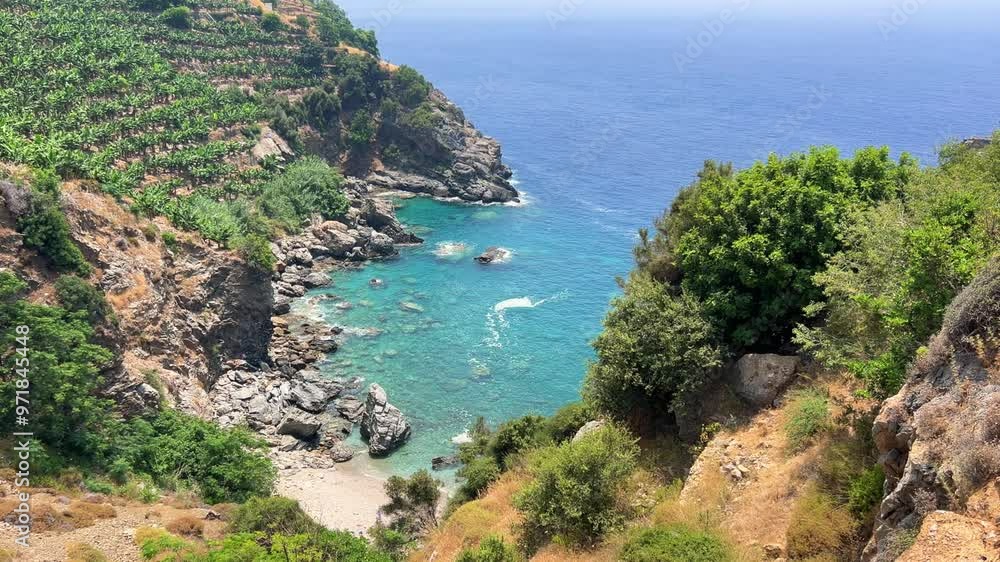 The blue lagoon in Gazipasha. A beautiful sea bay with mountains overgrown with shrubs and banana plantations descending to the sea with the purest water in the village of Guney koyu in Gazipasa. 4К The blue lagoon in Gazipasha. A beautiful sea bay with mountains overgrown with shrubs and banana plantations descending to the sea with the purest water in the village of Guney koyu in Gazipasa. 4К