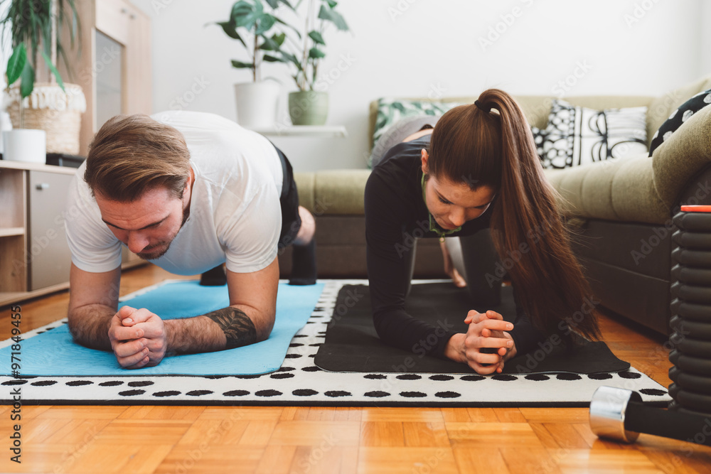 Young caucasian couple working out at home Young caucasian couple working out at home