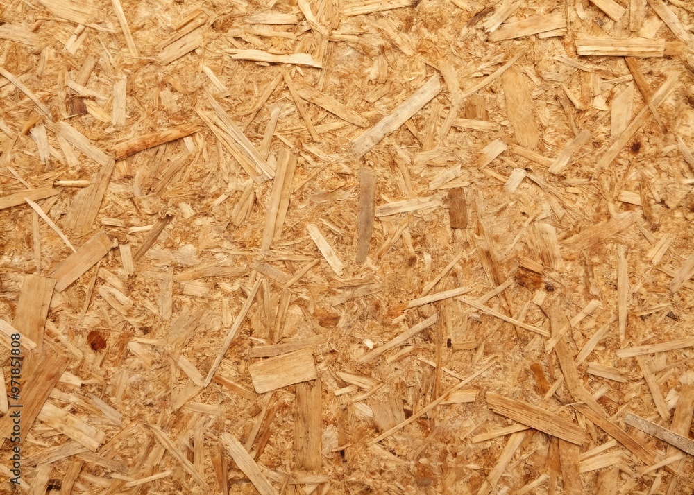 A close-up of a sheet of brown particle board, showcasing its textured surface and layered wood fibers, with A close-up of a sheet of brown particle board, showcasing its textured surface and layered wood fibers, with