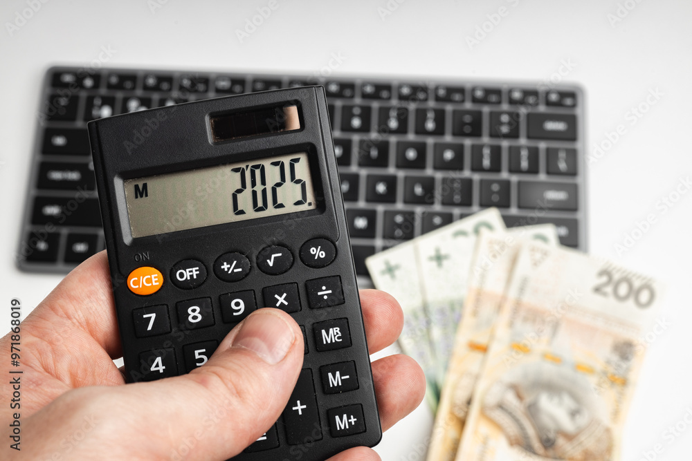Calculator held in hand with the year Calculator held in hand with the year