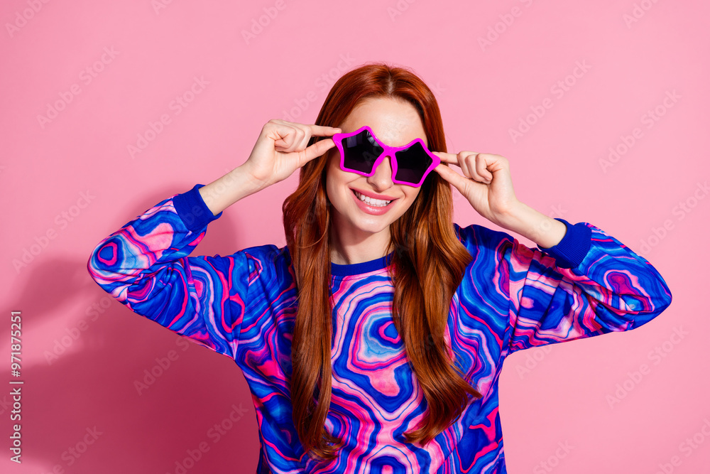 Photo of lovely young woman touch sunglass wear pullover isolated on pink color background Photo of lovely young woman touch sunglass wear pullover isolated on pink color background