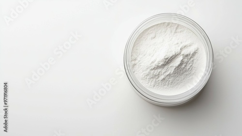 A white powder is in a glass container photo