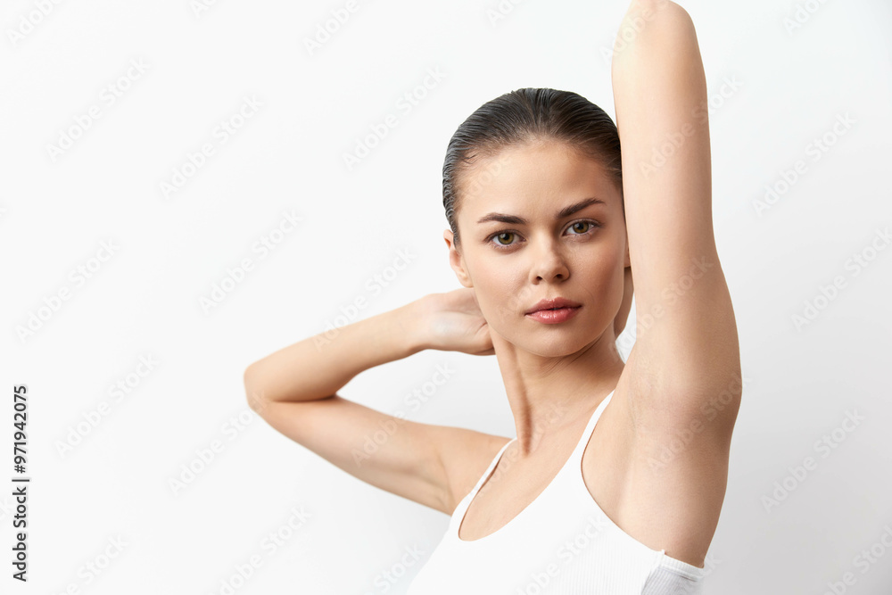 Model with smooth skin posing against a white backdrop, showcasing a natural look and elegant stance The image conveys beauty, confidence, and simplicity Perfect for beauty and fashion themes Model with smooth skin posing against a white backdrop, showcasing a natural look and elegant stance The image conveys beauty, confidence, and simplicity Perfect for beauty and fashion themes