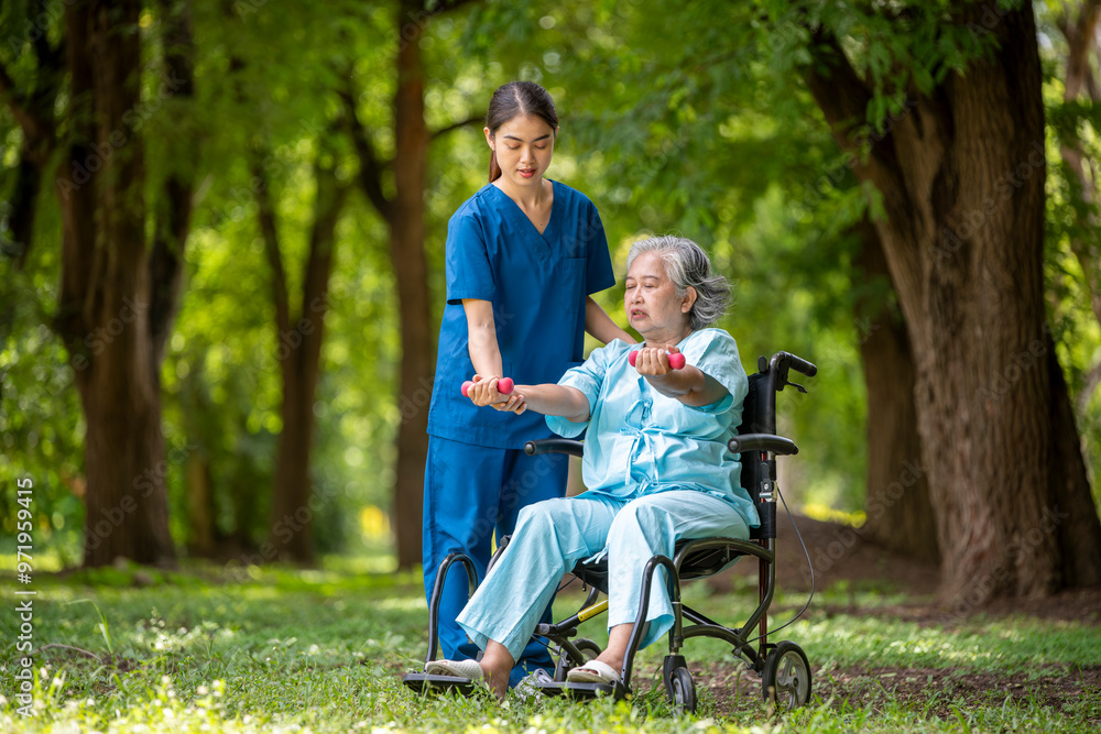 Healthcare or physical therapy nurse is helping elderly holding small dumbbells and appears engaged in an exercise routine caregiver individuals focused on rehabilitation exercises elder concept. Healthcare or physical therapy nurse is helping elderly holding small dumbbells and appears engaged in an exercise routine caregiver individuals focused on rehabilitation exercises elder concept.