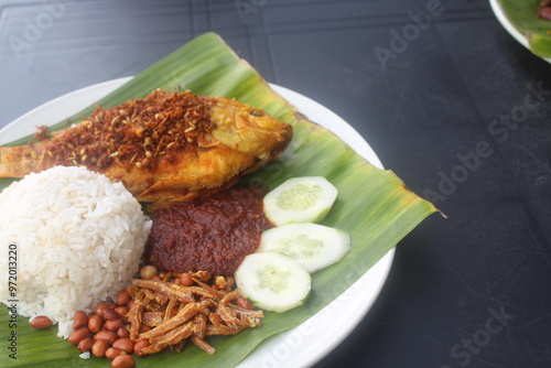 coconut rice with variety side meal such as fish chicken eggs meat and etc Nasi Lemak Berlauk