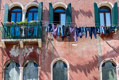 Fototapeta Naklejka Na Ścianę i Meble -  Laundry hanging from a clothes line outside a window on the street in Venice, Italy