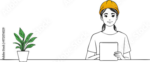 A female engineer seated at a table, holding a tablet. 