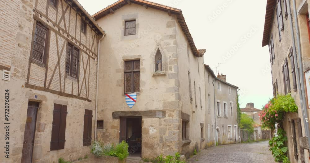 View of a street and houses in the medieval walled town of Parthenay, France. View of a street and houses in the medieval walled town of Parthenay, France.