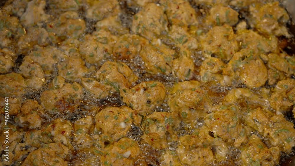 Frying fish cakes in boiled palm oil for sale in the market. Frying fish cakes in boiled palm oil for sale in the market.