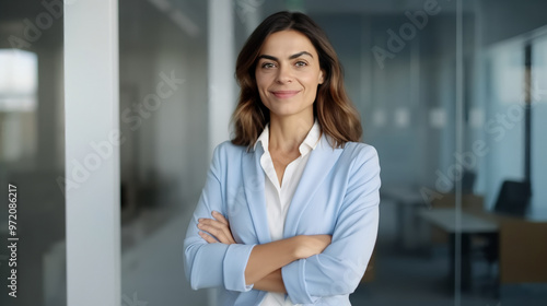 A portrait of an attractive and confident female business professional standing before a glass wall. Free Download A portrait of an attractive and confident female business professional standing before a glass wall. - GFXLoad
