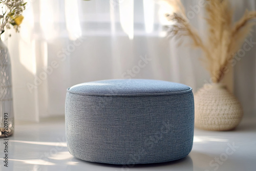 Stylish ottoman with a fabric cover on a white surface photo