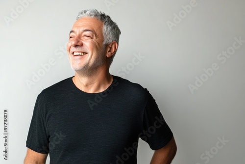 Senior man with grey hair smiling confidently.