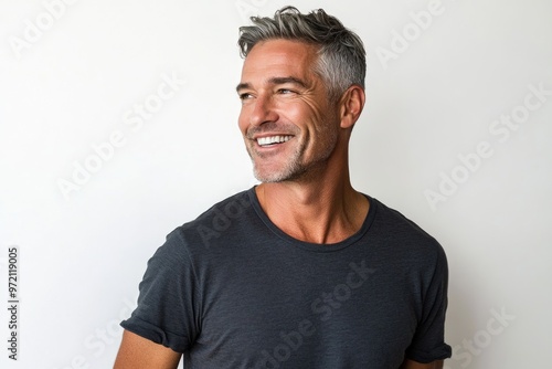 Confident middle aged man smiling in casual attire.