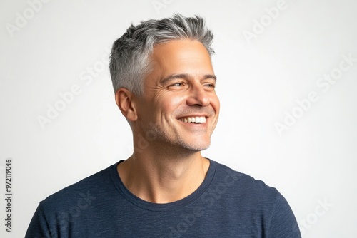 Confident middle aged man smiling in casual attire.