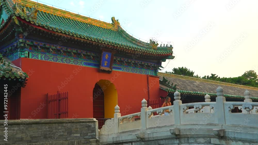Young blonde tourist strolling in the gardens of the Chinese temple of the heaven. Young blonde tourist strolling in the gardens of the Chinese temple of the heaven.