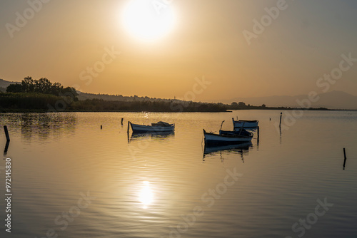 Fishermans boats in the Karina region near the Soke district of Aydin province Turkey are warmed by sunlight at sunrise photo