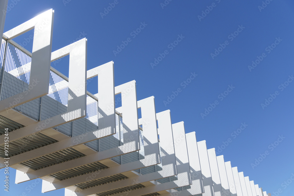 Fototapeta premium white metal structure of a flyover with a blue sky background