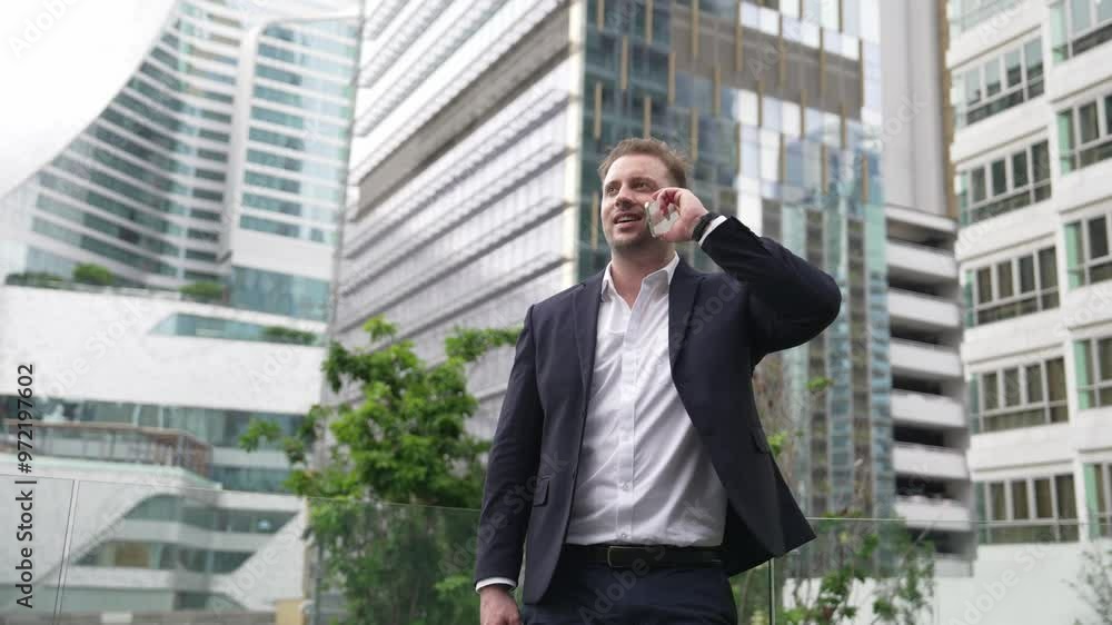 Skilled businessman talking to marketing team about marketing strategy by using phone while standing at skyscraper. Happy manager calling colleague about increasing sales at modern urban city. Urbane. Skilled businessman talking to marketing team about marketing strategy by using phone while standing at skyscraper. Happy manager calling colleague about increasing sales at modern urban city. Urbane.