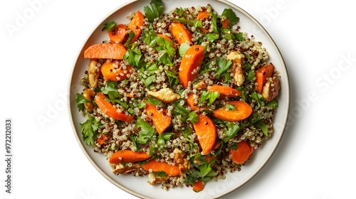 Healthy quinoa salad with carrots, walnuts, parsley, and greens on plate