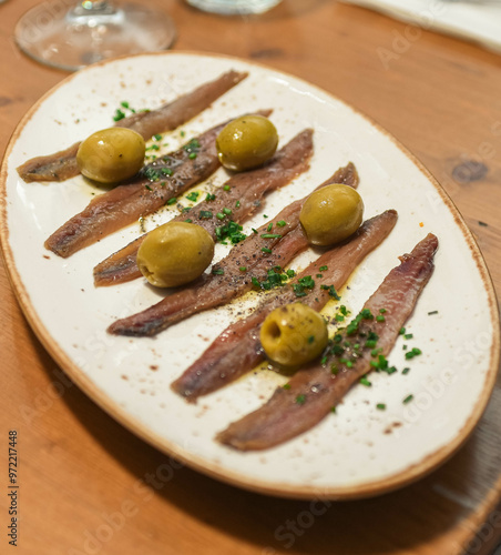 Plato de anchoas españolas con aceitunas photo