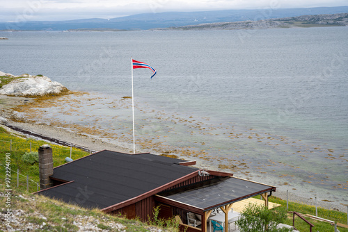 Norwegian flag on a house in Porsangerfjord in Norway photo