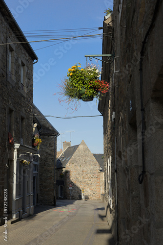 street in the city with flowers hanging photo