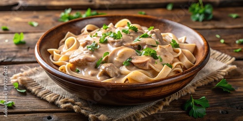 Close-up chicken stroganoff in ceramic bowl on rustic wooden table photo