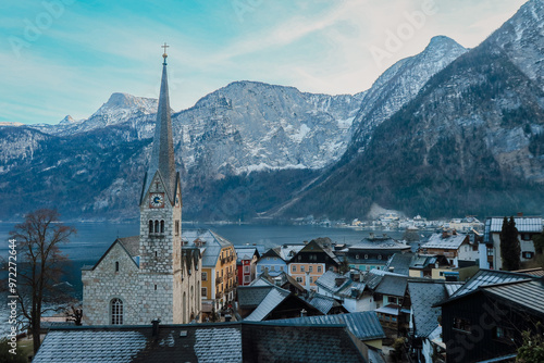 Exploring the serene beauty of Hallstatt, Austria with snow-capped mountains and historic architecture against a tranquil lake view