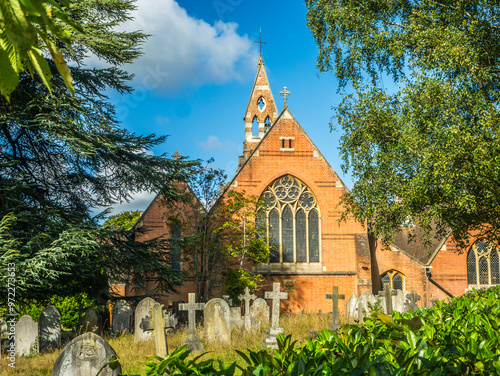 St Johns Church Crowthorne Berkshire UK. Blue sky showing windows and steeple photo