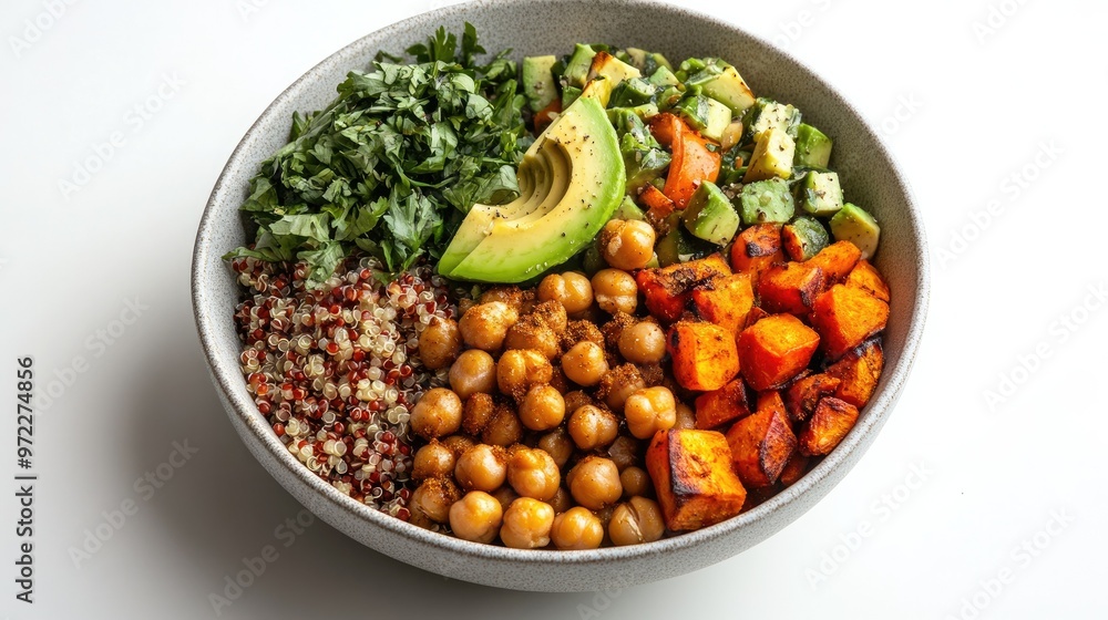 A vegan Buddha bowl with quinoa, chickpeas, avocado, and roasted vegetables, displayed on a white background A vegan Buddha bowl with quinoa, chickpeas, avocado, and roasted vegetables, displayed on a white background