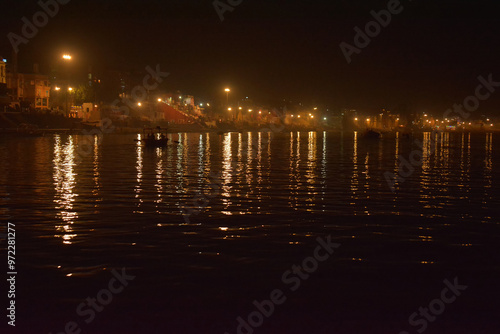 Night view of the Varanasi city reflection in river Ganga, Uttar pradesh, India