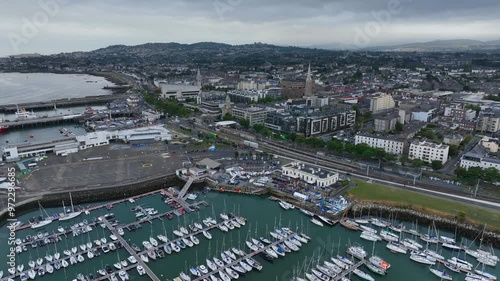 Dún Laoghaire, Dublin, Ireland, September 2024. Drone orbits counter clockwise above the Marina tracking right towards the Royal Irish Yacht Club on Harbour Road with Killiney Hill in the distance. photo