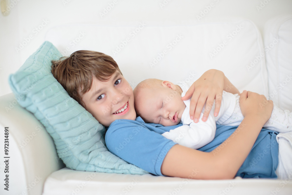 Child watching newborn baby in bassinet. Child watching newborn baby in bassinet.