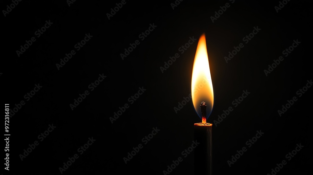 Single candle burning brightly in the dark. Single candle burning brightly in the dark.