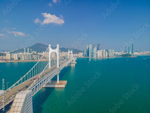 Suyeong-gu, Busan, South Korea - October 17, 2020: Aerial view of cars running on Gwangan Bridge of Suyeong Bay with the background of highrise apartments